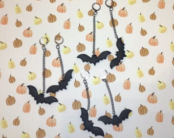 Swooping bat matte finish with orange sparkle clay dangle earrings