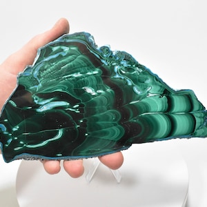 May include: A large, green and blue malachite slab with swirling patterns. The slab is polished and has a smooth surface.