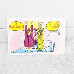 May include: A vintage postcard featuring a cartoon illustration of three people. The woman in the pink coat is saying "Do something!" and the man in the green coat is saying "I think I have".