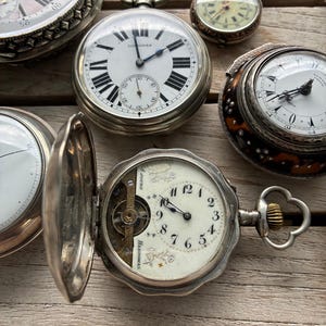 Pocket watch, Hebdomas, 8-day movement, sterling silver case, exposed balance, Flower dial, enamel, early 1900s, Switzerland