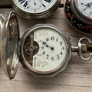 Pocket watch, Hebdomas, 8-day movement, sterling silver case, exposed balance, Flower dial, enamel, early 1900s, Switzerland