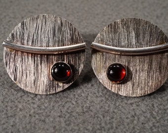 vintage sterling silver post earrings with brushed round plates set with bent tube accents and round smooth garnets   M2