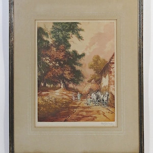 May include: A framed print of a rural landscape with a dirt road leading to a stone building. The scene is painted in warm tones of brown, green, and orange. There are trees on either side of the road, and a horse-drawn cart is parked in front of the building. The print is signed "Bellflower" in the bottom right corner.
