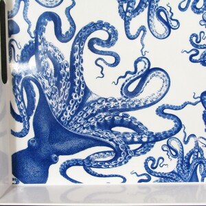 May include: White rectangular serving tray with a blue octopus pattern. The tray features a repeating design of detailed octopuses in a classic blue and white color scheme. The tray has built-in handles for easy carrying.