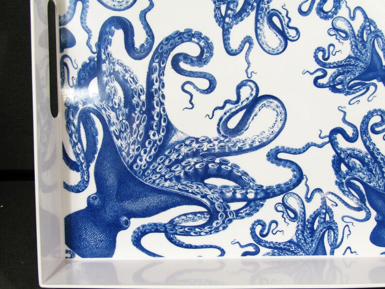 May include: White rectangular serving tray with a blue octopus pattern. The tray features a repeating design of detailed octopuses in a classic blue and white color scheme. The tray has built-in handles for easy carrying.