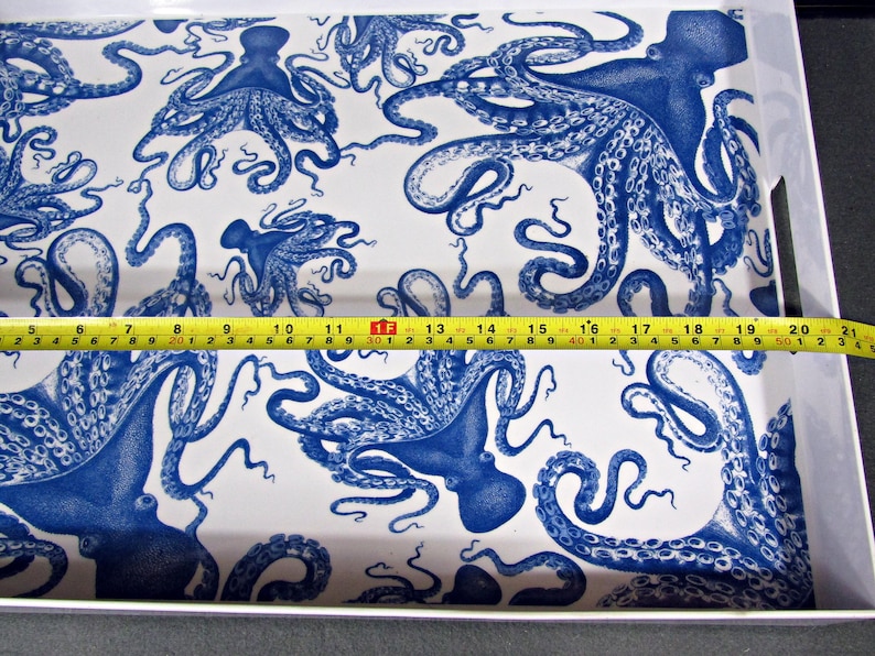 May include: A rectangular serving tray with a white background and a repeating pattern of blue octopus illustrations. The tray measures approximately 20 inches long.