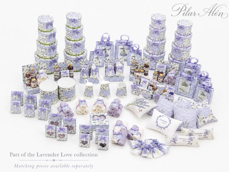 May include: A collection of miniature decorative items featuring lavender floral patterns and purple gingham accents, including stacked round boxes, gift bags, small pillows, towels, and containers, with the text Pilar Al&eacute;n and Lavender Love.