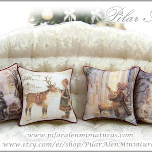 May include: Five decorative throw pillows with a white background and a variety of winter holiday scenes. The pillows have red trim and are arranged on a white couch.