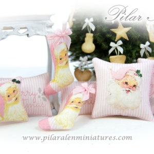 May include: Pink and white striped pillow with the text "Merry Christmas" and a Santa Claus illustration.  There are three other pillows with Santa Claus illustrations and the text "Merry Christmas".