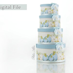 May include: Set of four round nesting boxes with a blue and white design featuring a watercolor illustration of pumpkins and apples. The boxes are stacked on top of each other.