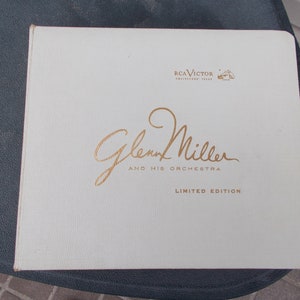 May include: A white vinyl record album cover with gold lettering. The cover features the text "RCA Victor Collector's Item" and "Glenn Miller and His Orchestra Limited Edition".