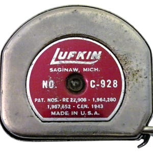 May include: Vintage Lufkin measuring tape with a silver metal casing and a red and white label. The label includes the text "Lufkin Saginaw, Mich. No. C-928" and "Made in U.S.A."