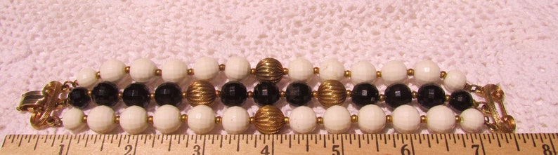 LISNER Black White Beads with Fancy Fluted Gold Tone Accents Bracelet