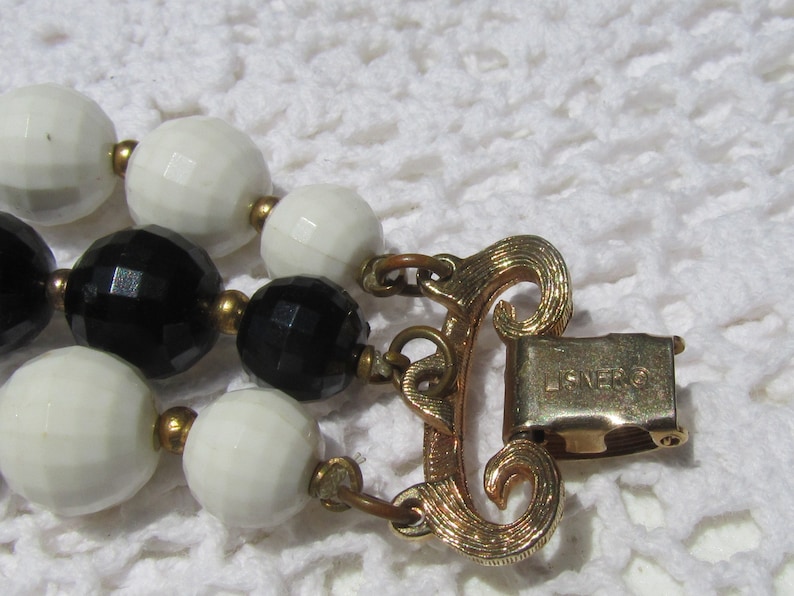 LISNER Black White Beads with Fancy Fluted Gold Tone Accents Bracelet