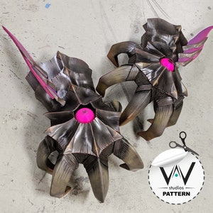 May include: Two detailed, dark brown, 3D printed, fantasy creature sculptures with pink glowing eyes. Each sculpture has multiple legs and a spiky, textured surface.