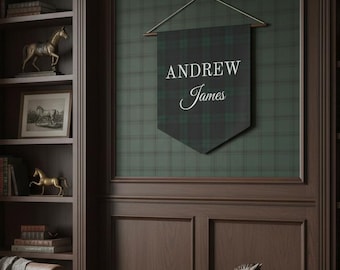 May include: A room with a leather armchair, a bookshelf, and a wall hanging. The wall hanging is a plaid banner with the name "Andrew James" in white script. A wooden rocking horse and gold horse figurines are also visible.