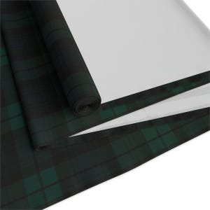 May include: A fabric roll featuring a dark green and black plaid tartan pattern. The material is partially unrolled, revealing a solid white underside. The textile displays a consistent grid of intersecting dark lines and deep green blocks.