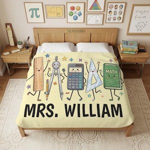 May include: A light yellow bedspread featuring a cartoon graphic of a ruler, compass, calculator, triangle, and a book labeled MATH, all with smiling faces. The text MRS. WILLIAM is printed in large black letters at the bottom of the blanket.