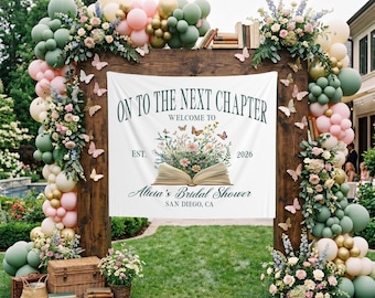 May include: A wooden archway decorated with balloons, flowers, and butterflies. A banner reads "ON TO THE NEXT CHAPTER" with "Welcome to" and "Alicia's Bridal Shower, San Diego, CA." The arch is set on a grassy lawn.