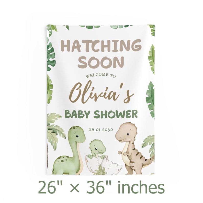 May include: A rectangular baby shower banner with the text "Hatching Soon" and "Olivia's Baby Shower." The banner features illustrations of dinosaurs and tropical leaves. The banner measures 26 x 36 inches.