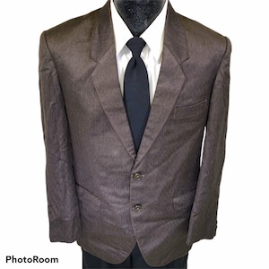 May include: A brown blazer with a subtle striped pattern. The blazer has a two-button closure and a single chest pocket.