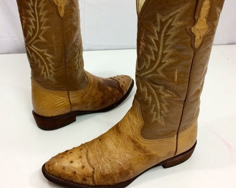 May include: A pair of brown ostrich leather cowboy boots with a pointed toe and intricate embroidery on the shaft.