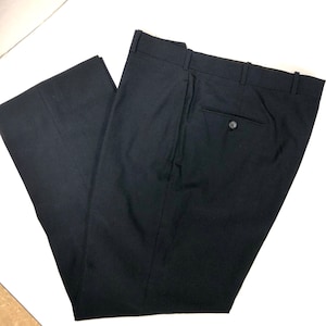 May include: Black dress pants with a single back pocket and a button closure.