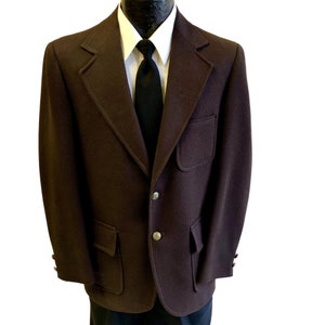 May include: A brown blazer with two large patch pockets and a single button closure. The blazer has a textured fabric and a classic fit.
