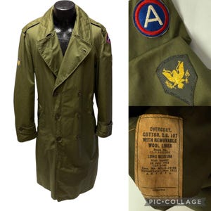May include: A green military overcoat with a removable wool liner. The coat has a double-breasted closure, two large pockets, and a patch on the left sleeve. The label on the coat reads "Overcoat, Cotton, O.G. 107 with Removable Wool Liner, Stock No. 55-0-1650-205, Long Medium, Nick Ippoliti, 26 June 1953, TAP 2443, Spec. No. MIL-D-24198, Pattern Date 12 Nov. 1951, A.S.T.A.P.A."
