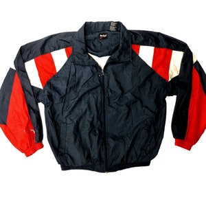 May include: A black, red, and white windbreaker jacket with a zipper closure. The jacket has a contrasting color design on the sleeves and shoulders.