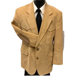 May include: A tan corduroy blazer with a suede elbow patch and two button closure.