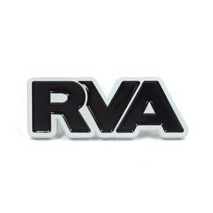 May include: Black and white enamel pin with the letters RVA in a bold, stylized font.