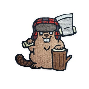 May include: Embroidered patch of a cartoon beaver wearing a red and black plaid lumberjack hat and holding an axe and a log.