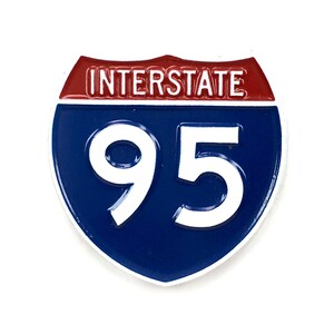 May include: A blue and red interstate highway sign with the number 95 in white.