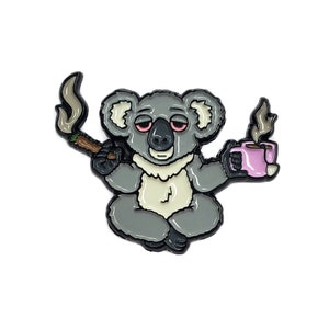 May include: A gray koala bear with red eyes sits in a meditative pose, holding a lit joint in one hand and a pink mug of coffee in the other. The koala is surrounded by a white background.