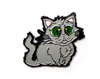 May include: A gray enamel pin of a cartoon cat with large green eyes and a pink nose. The cat is sitting with its tail curled around its body.
