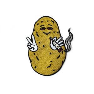 May include: Embroidered patch featuring a cartoon potato with red eyes, holding a lit joint and giving a peace sign. The potato is yellow with a textured appearance, and the joint emits gray smoke. The patch is on a white background.