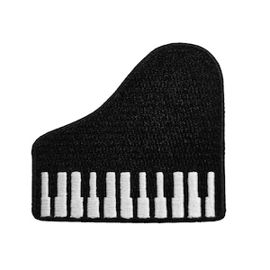 May include: Black piano-shaped patch with white piano keys. The patch is a stylized representation of a grand piano, featuring a curved top and a rectangular base with the keys. The design is simple and bold, suitable for music lovers.