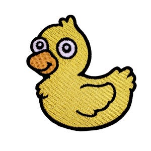 May include: Yellow rubber duck with large eyes and a small beak. The duck is embroidered with a textured yellow fabric.