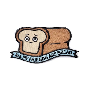May include: Embroidered iron-on patch featuring a cartoon bread loaf with a smiling face and the text "All my friends are bread" on a blue ribbon.