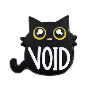 May include: Black enamel pin featuring a cartoon black cat with yellow eyes and a white mouth. The cat is sitting with its tail curled around its body. The word "VOID" is written in white letters on the cat's belly.
