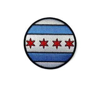 May include: A round embroidered patch featuring the Chicago flag. The flag is white with blue stripes and four red stars.