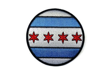 May include: A round embroidered patch featuring the Chicago flag. The flag is white with blue stripes and four red stars.