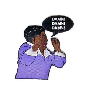 May include: An embroidered iron-on patch featuring a cartoon character with a purple shirt and black hair, yelling "DAMN! DAMN! DAMN!" in a speech bubble.