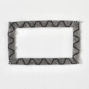 May include: A set of three ceramic mugs with a speckled, matte finish. The mugs are in shades of cream, light gray, and dark gray. Each mug has a simple, minimalist design, perfect for coffee or tea.