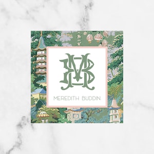 May include: A green and white monogrammed business card with a floral design. The monogram is "MB" and the text reads "Meredith Buddin".