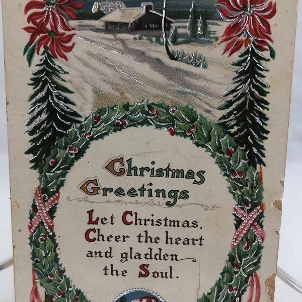 Christmas Greetings Antique Postcard Posted Idaho 1914 Embossed Santa Silver Bell Snow Scenery In Green Wreath Made in Germany