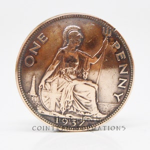 May include: A 1937 British one penny coin featuring a seated figure of Britannia wearing a helmet and holding a trident. The coin displays the text ONE PENNY and the year 1937, with a lighthouse visible in the background behind the figure.