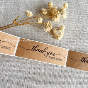 May include: Brown kraft paper thank you stickers with the text "The Paper Crafterie" and "thank you for your purchase".