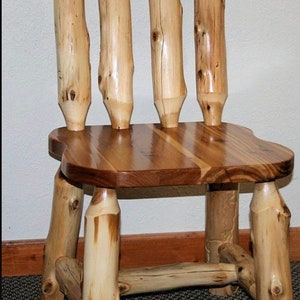 May include: A rustic wooden chair with a natural wood finish. The chair has a slatted seat and a back with four vertical slats. The chair is made of rough-hewn logs and has a natural, rustic look.